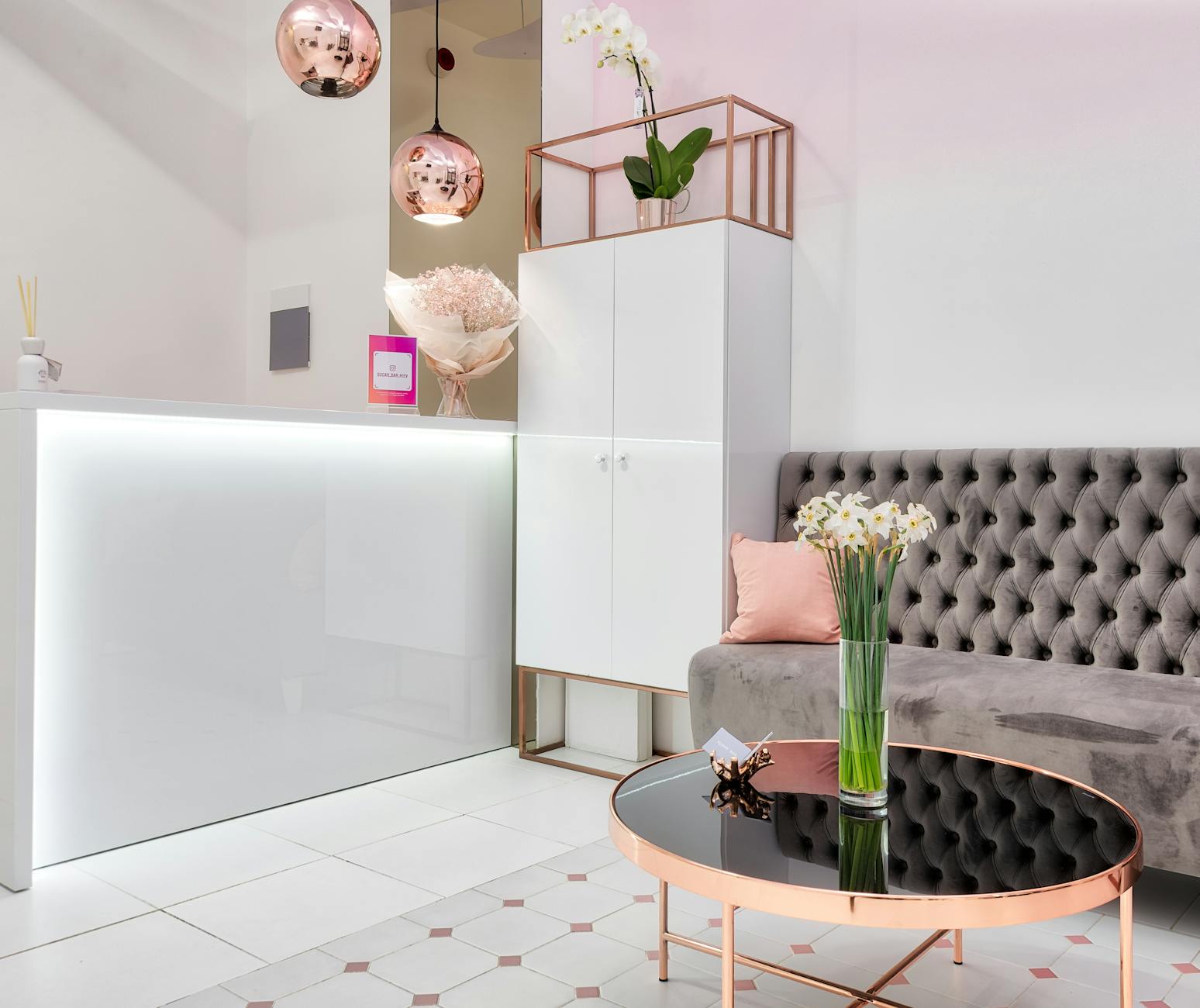 Nowoczesny, butikowy lounge hotelowy z welurową sofą i kwiatową dekoracją